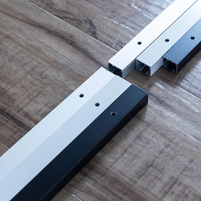 Comparing the three different colors (standard aluminum, black, or white) of the aluminum track systems.